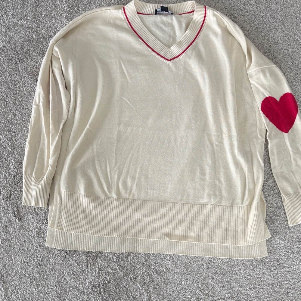Studio Cream V-Neck Sweater with Red Heart Accent
